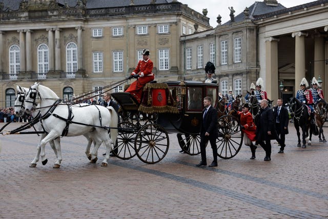 Denmark’s Queen Margrethe II is escorted by the Guard Hussar Regiment’s Mounted Squadron in the gold carriage from Amalienborg Castle to Christiansborg Castle