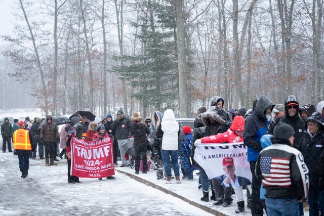 Donald Trump supporters queues during a winter snowstorm to enter a campaign event in Atkinson, NH, on Tuesday