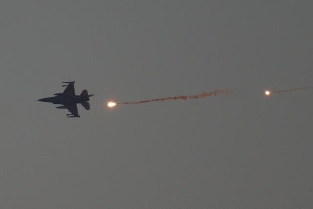 An Israeli fighter jet releases flares as it flies over the Gaza Strip on Tuesday