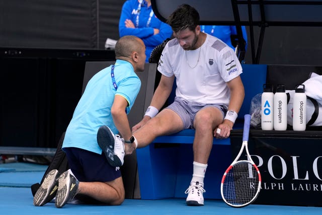 Cameron Norrie receives treatment to his right knee 