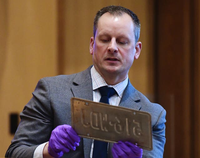 Sergeant Michael Beauton shows an allegedly altered license plate from a vehicle previously owned by Fotis Dulos