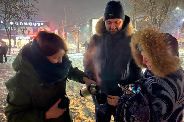 People drink tea in a street after leaving their in apartment buildings after an earthquake in Almaty, Kazakhstan