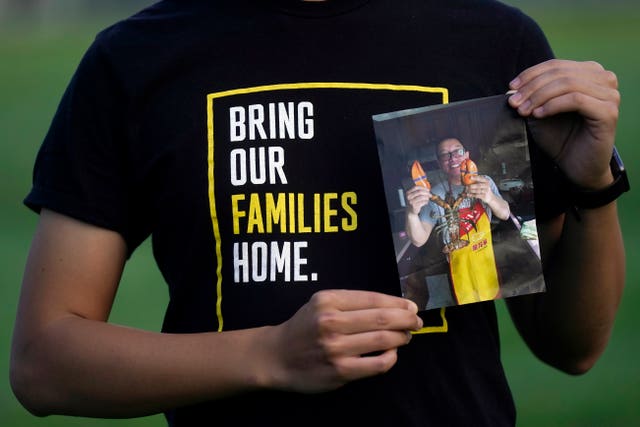 Harrison Li holds a photo of his father, Kai Li