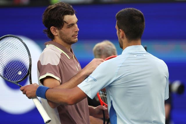 Taylor Fritz, left, congratulates Novak Djokovic