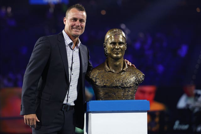 Lleyton Hewitt stands with his bust