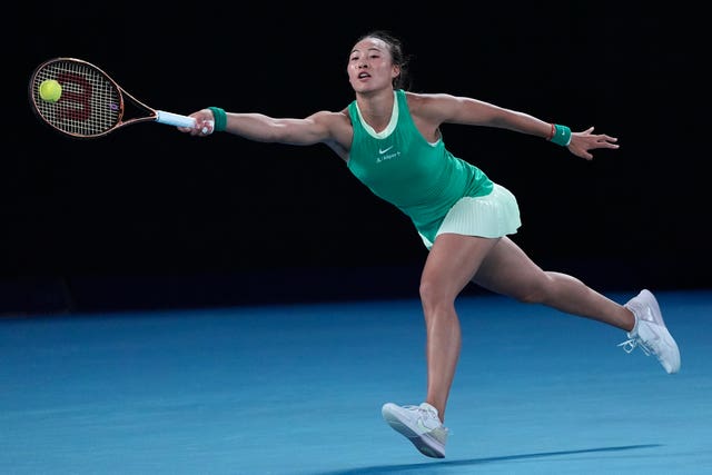 Zheng Qinwen stretches for a forehand