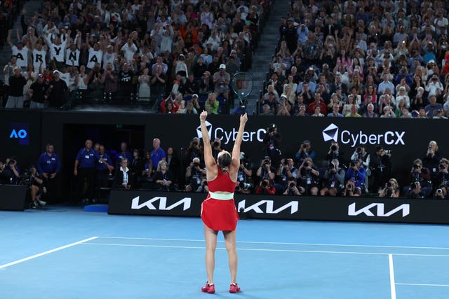 Aryna Sabalenka thrusts her arms into the air after beating Zheng Qinwen in the final 