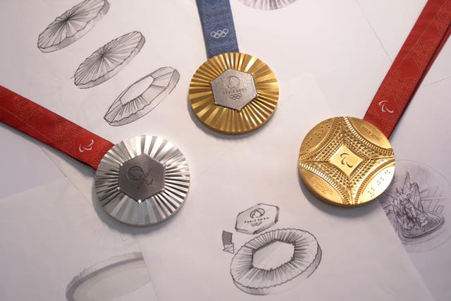 The Paris 2024 Olympic gold medal, centre, the Paris 2024 Paralympic, gold medal, right, and silver medal, left, are presented to the press in Paris