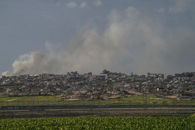 Smoke rises behind rubble from buildings destroyed in the Israeli Army’s ground operation in the Gaza Strip as seen from southern Israel, adjacent to the Gaza border fence
