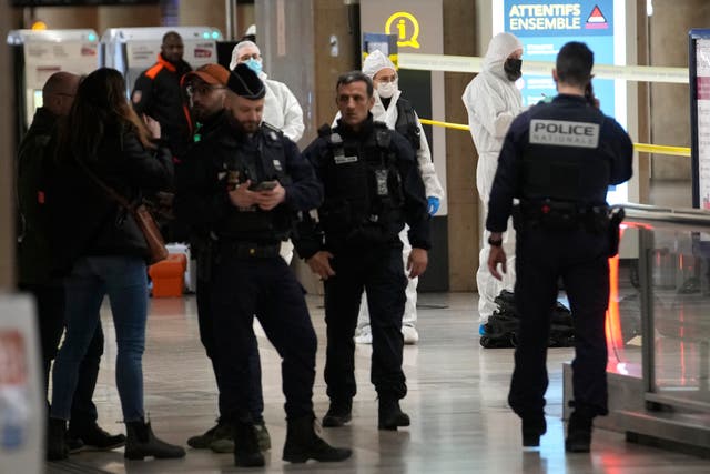 Police investigators work inside the Gare de Lyon station