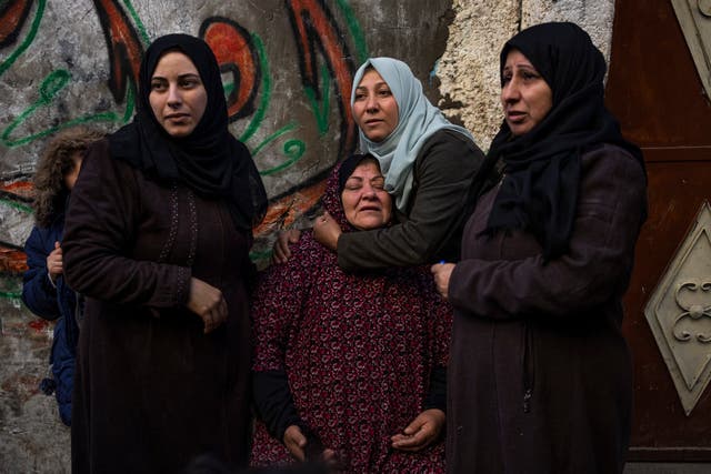 Palestinian women react after their home was hit by an Israeli strike in Rafah, southern Gaza Strip
