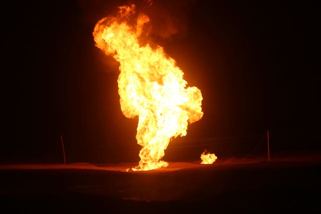 Flames leap into the air after a natural gas pipeline explodes outside the city of Boroujen in Iran (Reza Kamali Dehkordi/AP)