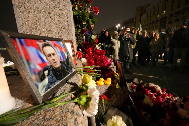 A portrait of Russian opposition leader Alexei Navalny, and flowers are laid on the Memorial to Victims of Political Repression as people come to lay flowers paying their last respect to Alexei Navalny in St Petersburg, Russia
