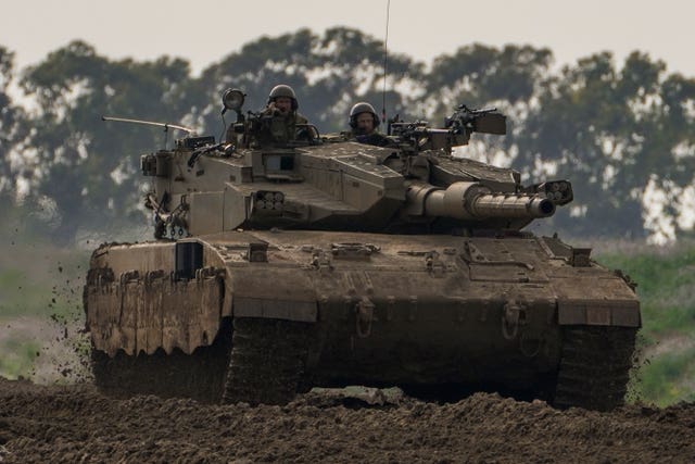 Israeli soldiers drive a tank near the Gaza Strip border in southern Israel 