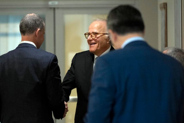Republican staff lawyer Steve Castor, left, shakes hands with James Biden, the brother of President Joe Biden, during a break of a private interview with House Republicans