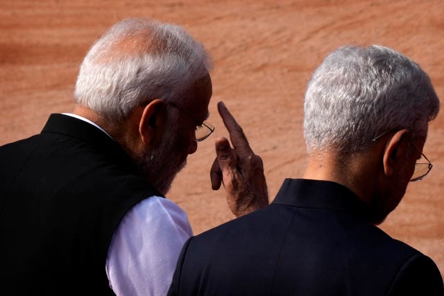 Indian Prime Minister Narendra Modi, left, talks with India's foreign minister S Jaishankar as they arrive for the ceremonial reception of Greek Prime Minister Kyriakos Mitsotakis (Manish Swarup/AP)