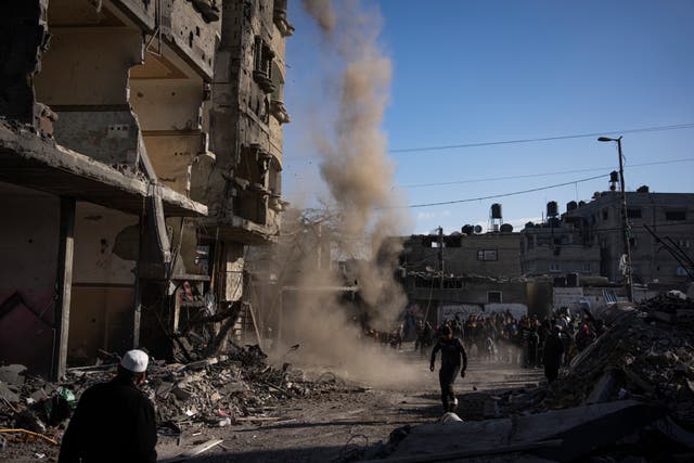 Palestinians look at air strike damage in Rafah