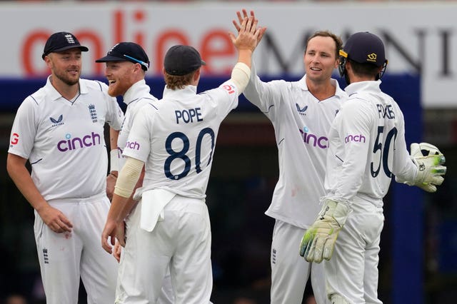 Tom Hartley (second right) celebrates a wicket