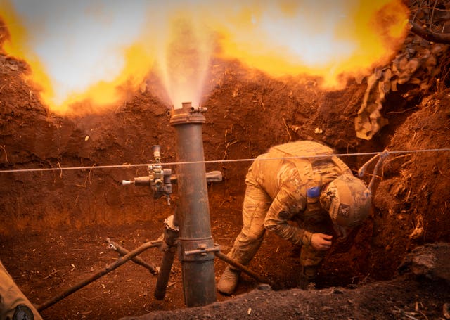 Ukrainian serviceman fires artillery