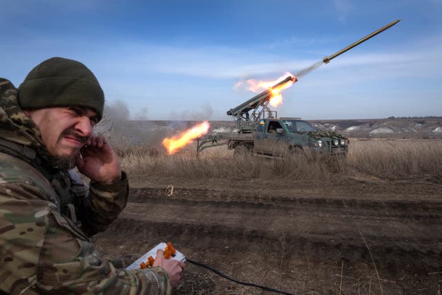 A Ukrainian officer fires a multiple launch rocket system towards Russian positions