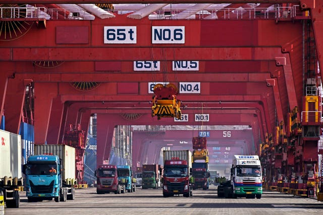 Containers are unloaded from a cargo ship at a port in China 