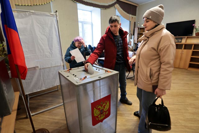 A man casts a ballot at a polling station