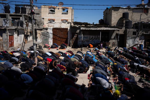 Palestinians perform the first Friday prayers of the Muslim holy month of Ramadan near the ruins of a destroyed mosque in Rafah