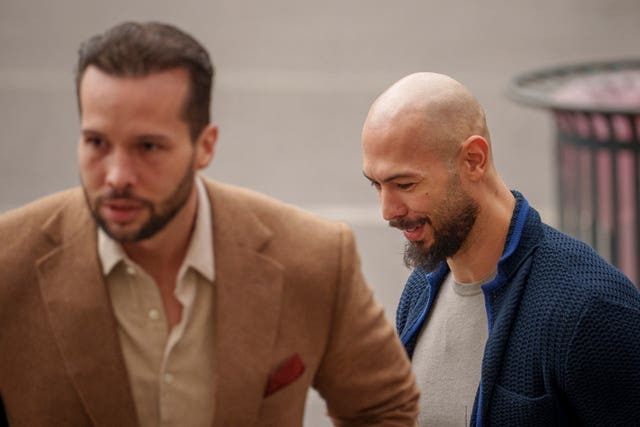 Andrew Tate, right, and his brother Tristan arrive at the Bucharest Tribunal in Bucharest, Romania, on March 15