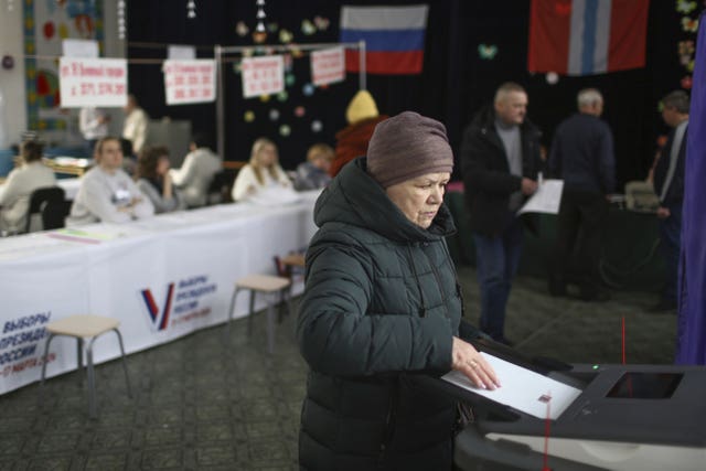 A woman casts a ballot in the Siberian city of Omsk 