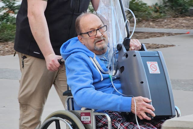 Jerry Hal Saliterman, of Crystal, Minnesota, is wheeled out of US District Court in St Paul, Minnesota, on March 15 2024 after he made his initial appearance on charges connected to the 2005 theft of a pair of ruby slippers worn by Dorothy in The Wizard Of Oz