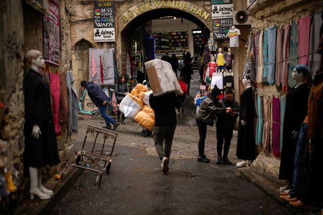 People carry goods in Eminonu trade neighbourhood in Istanbul, Turkey