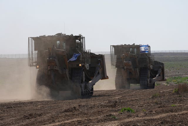 Israeli army bulldozers manoeuvre near the Gaza border in southern Israel 