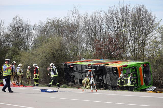 A coach lies overturned on its side at the scene of an accident on the A9, near Schkeuditz, Germany 