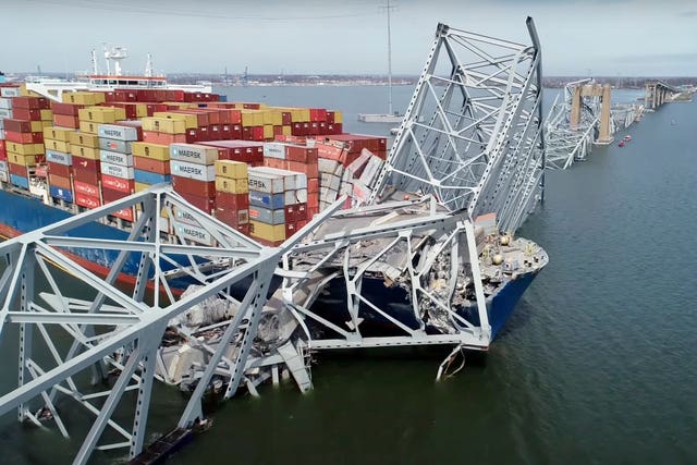 The cargo ship Dali is stuck under part of the structure of the Francis Scott Key Bridge after the ship hit the bridge in Baltimore