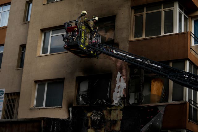 Firefighters work in the aftermath of a fire in a nightclub in Istanbul, Turkey