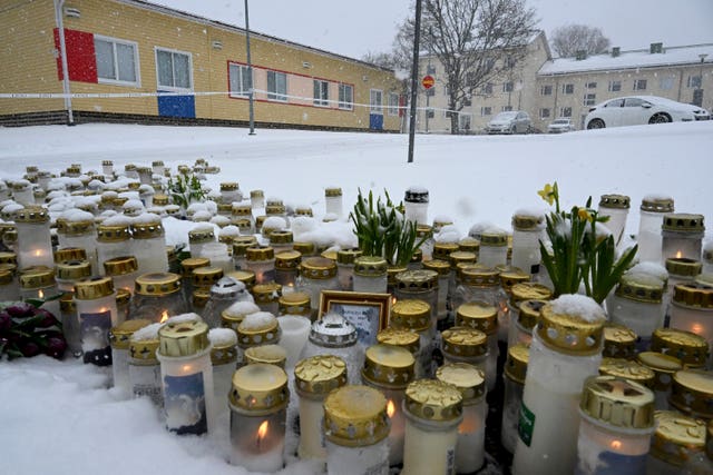 Candles and flowers left at the school