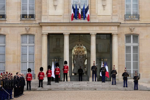 British and French soldiers stand guard at the Elysee Palace on Monday 