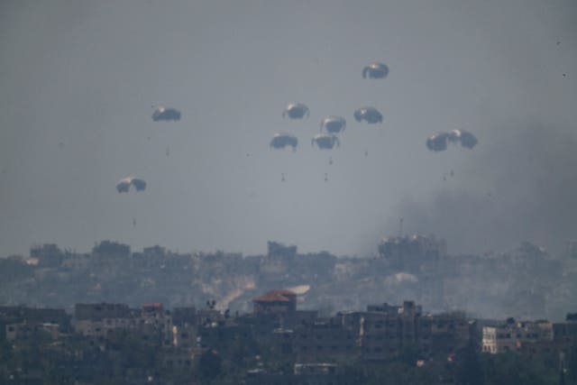 Parachutes drop supplies into the northern Gaza Strip as seen from southern Israel