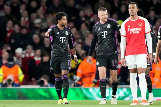 Bayern Munich’s Serge Gnabry, left, celebrates his goal as Arsenal''s Gabriel, right, shows his frustration