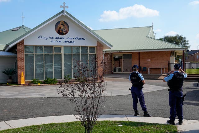 Police patrol outside the Christ the Good Shepherd church in suburban Wakely in western Sydney, Australia