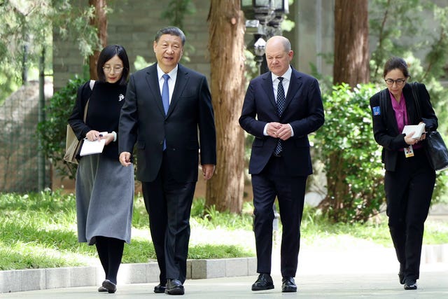 Chinese President Xi Jinping and German Chancellor Olaf Scholz walk together in Beijing, China