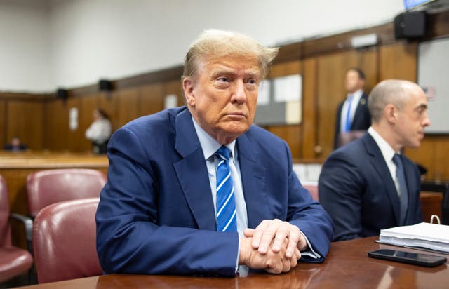 Former president Donald Trump awaits the start of proceedings on the second day of jury selection at Manhattan criminal court in New York