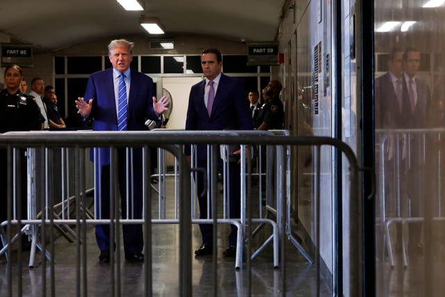 Former president Donald Trump speaks to the media as he arrives for the second day of jury selection at Manhattan criminal court in New York