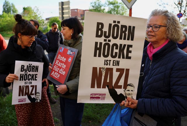 Protesters hold banners reading ‘Bjorn Hocke is a Nazi’ outside the state court in Halle, Germany