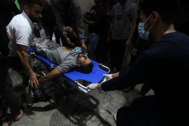 An injured Palestinian is brought to the Kuwaiti Hospital in Rafah refugee camp
