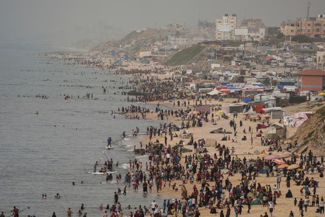 Palestinians spend the day on the beach along the Mediterranean Sea during a heatwave in Deir al Balah, Gaza Strip 