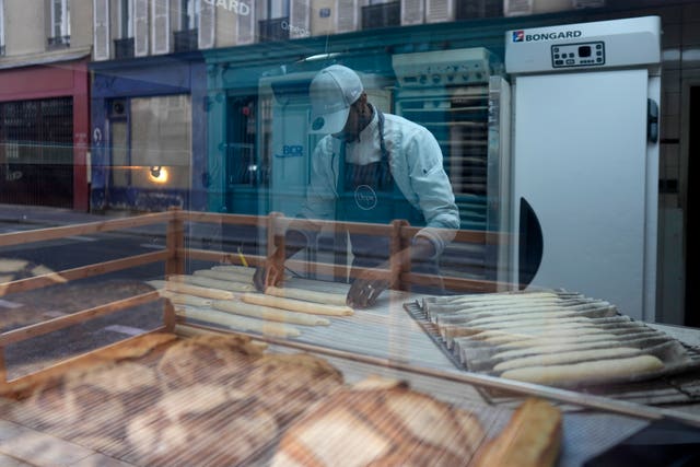 Baker Xavier Netry makes baguettes in the Utopie bakery in Paris