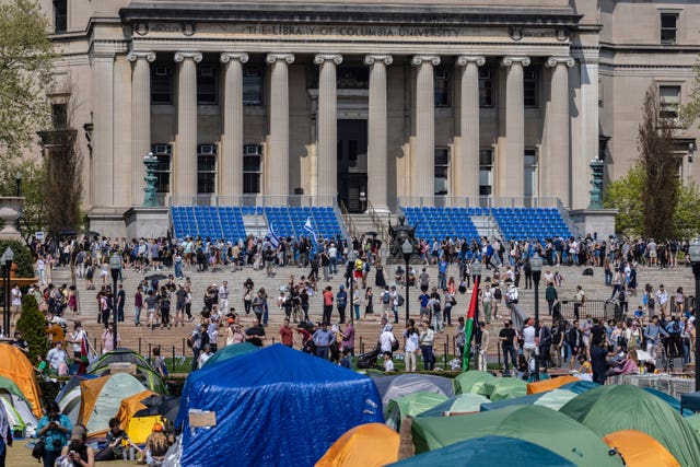 Student protesters march around their encampment at Columbia University 