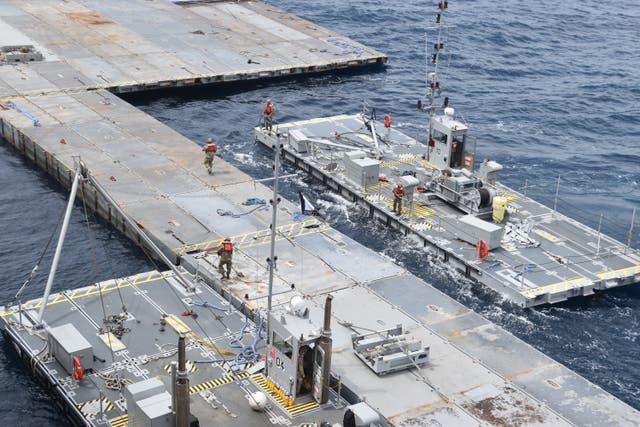 Soldiers assigned to the 7th Transportation Brigade (Expeditionary) and sailors attached to the MV Roy P Benavidez assemble the Roll-On, Roll-Off Distribution Facility (RRDF), or floating pier, off the shore of Gaza in the Mediterranean Sea