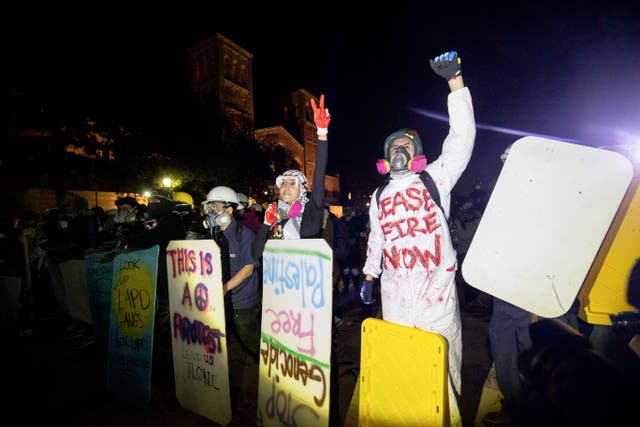Demonstrators with makeshift shields